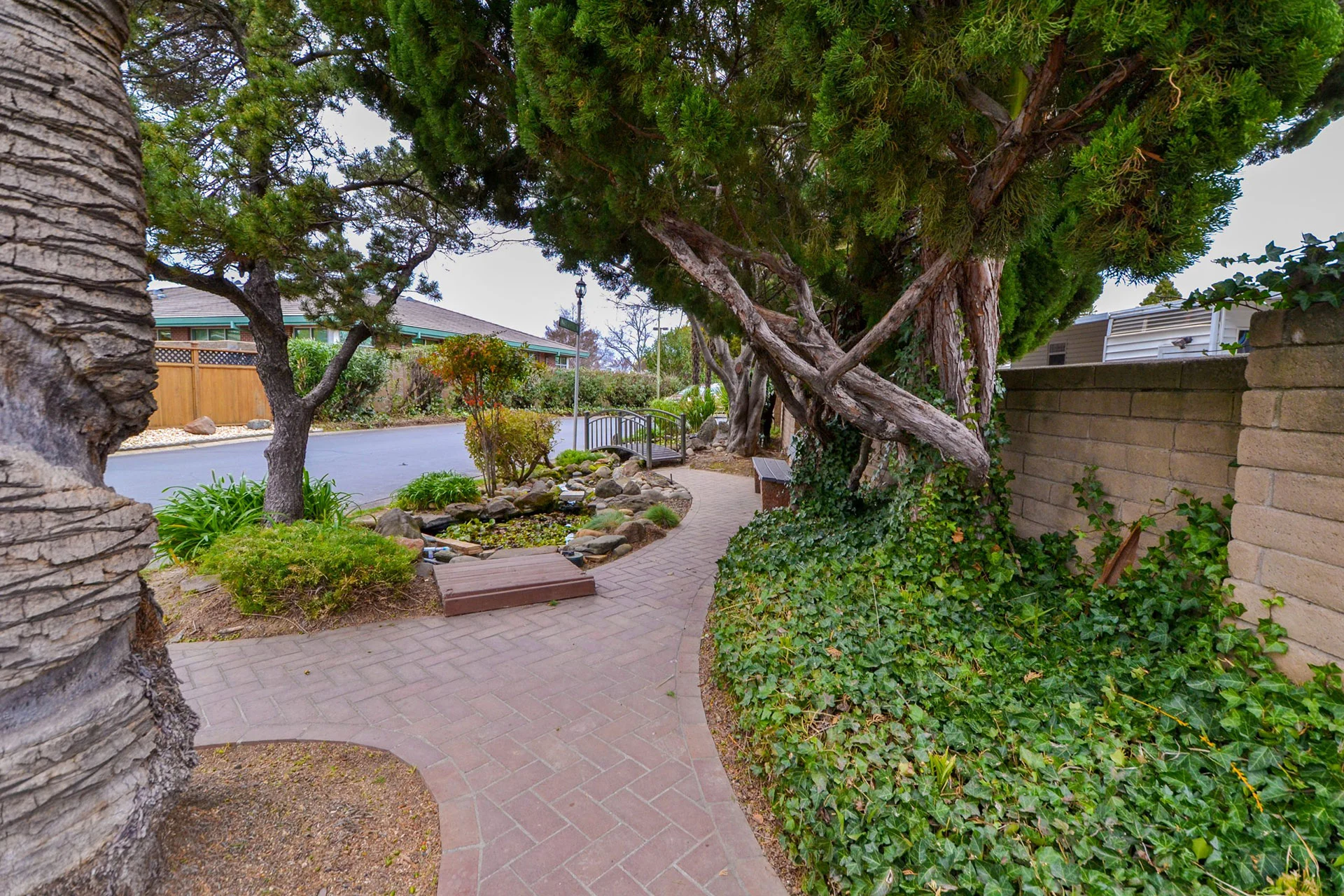 Community park by the road with trees in the senior mobile home park Mobil Country Club in Rancho Cordova, Sacramento County, CA